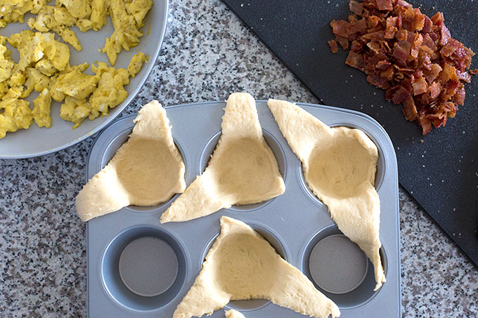 Crescent rolls pushed down into a muffin tin