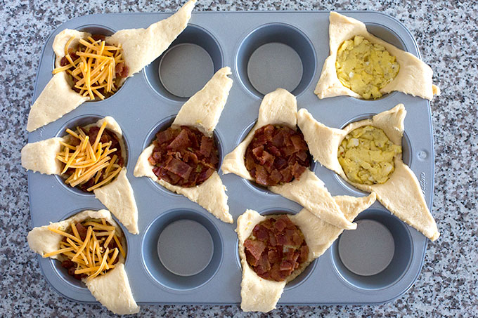 Bacon eggs and cheese stuffed into crescent dough in a muffin tin