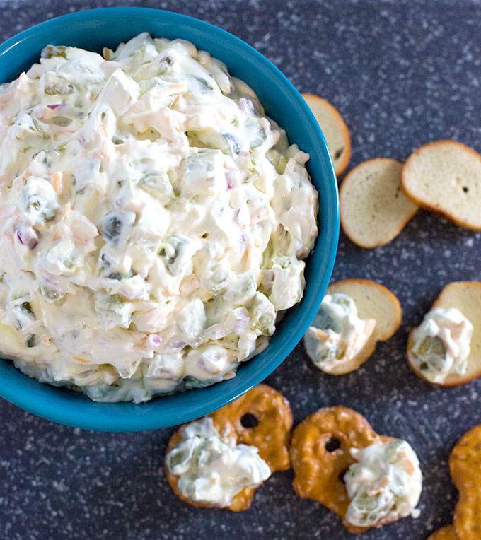 Bowl of Dill Pickle Dip with pretzel chips and melba toast for dippers