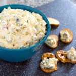 easy appetizer dill pickle dip in a bowl with pretzel chip dippers