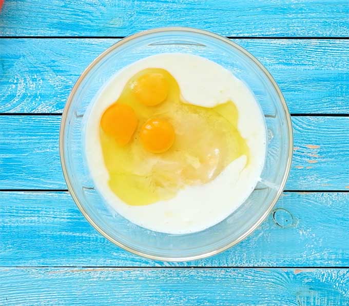 mixing bowl with sugar, buttermilk, eggs, melted butter, and vanilla for a custard pie