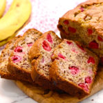 sliced raspberry banana bread on a cutting board