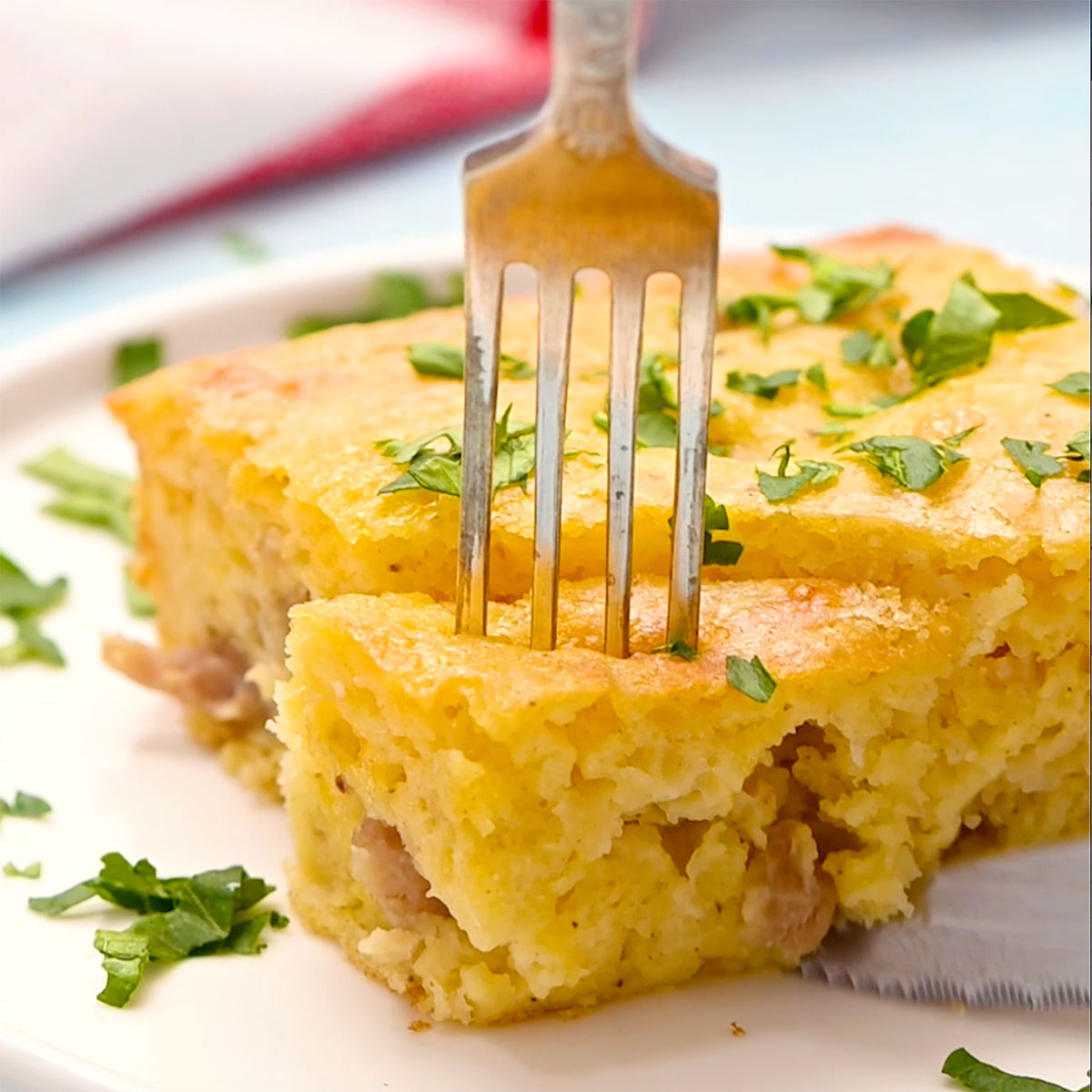 piece of sausage bisquick breakfast casserole on a plate with a fork going into it.