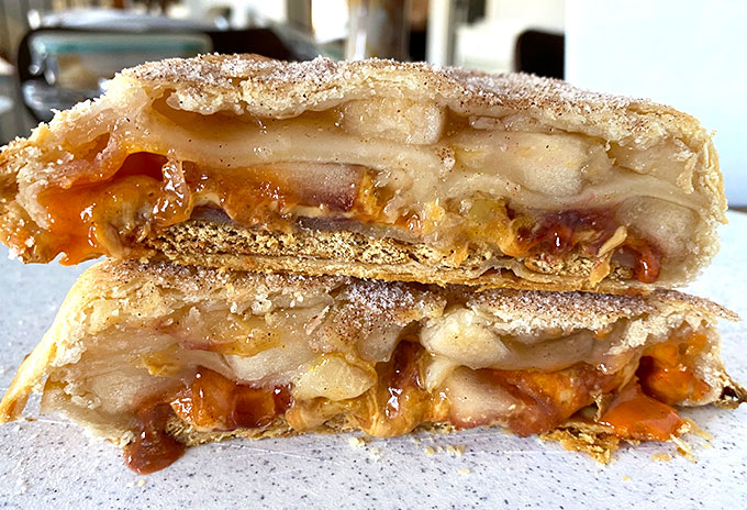 layers of folded apple pie, caramel, reeses pieces, and graham crackers cut in half.