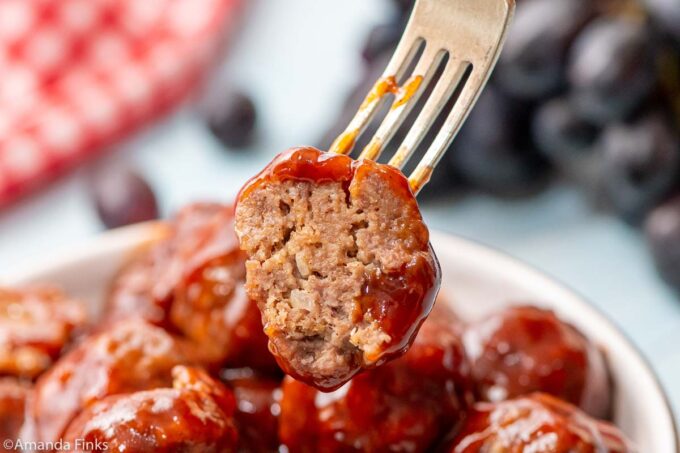 half of a meatball on a fork