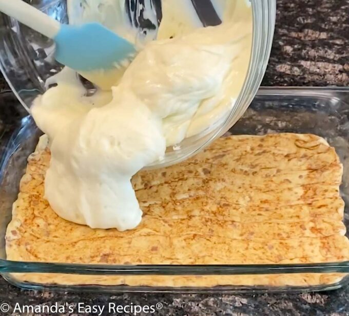 Pouring the cheesecake mixture over the cinnamon roll crust.