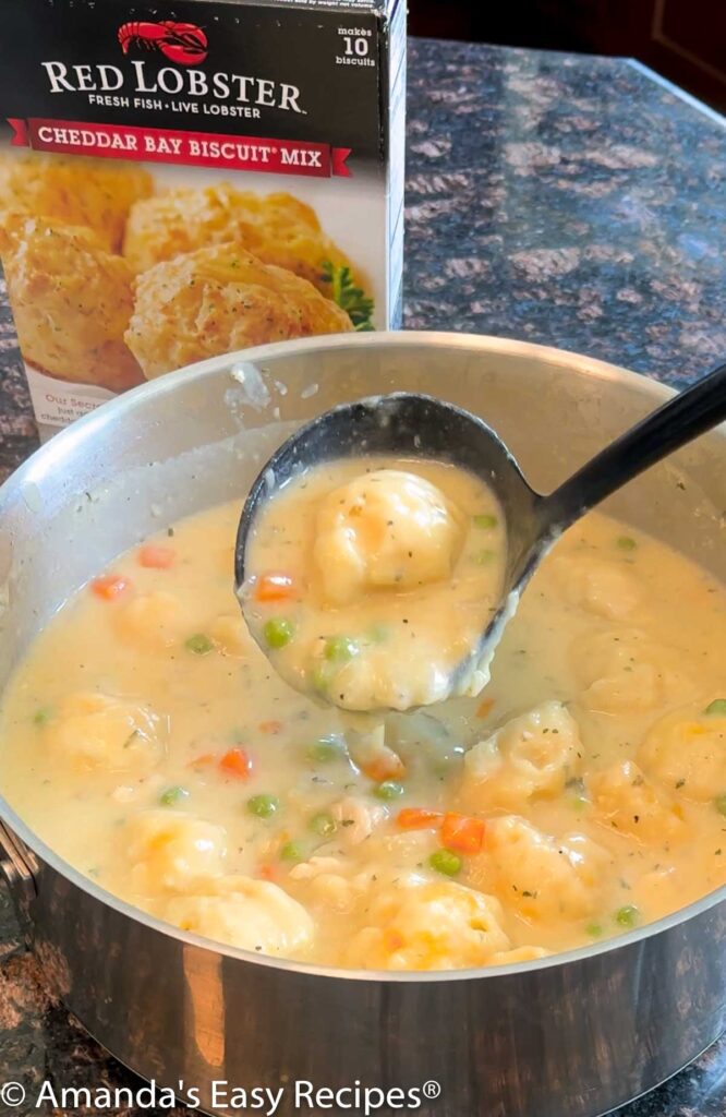 Pot full of chicken and dumplings made with cheddar bay biscuit mix.