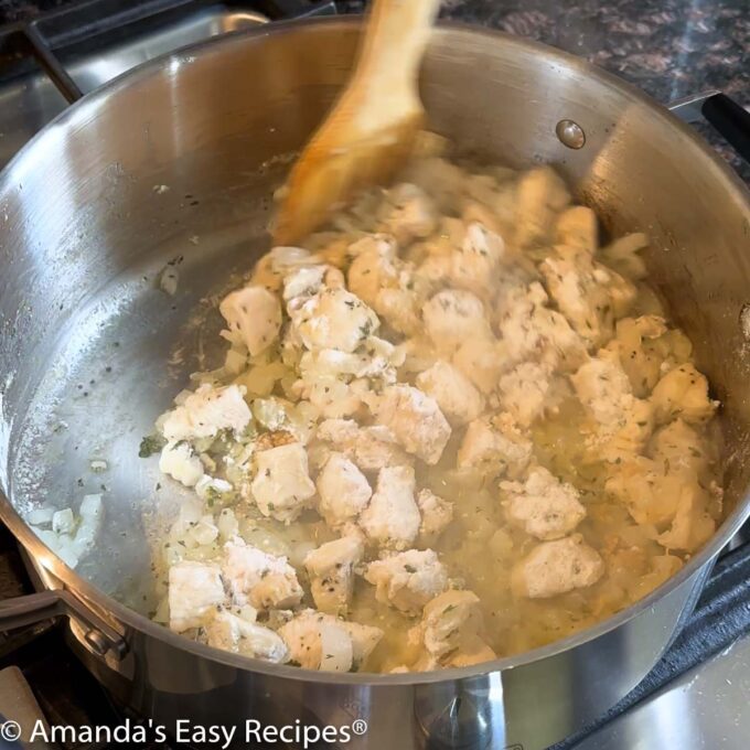 Adding garlic and flour to the pot.