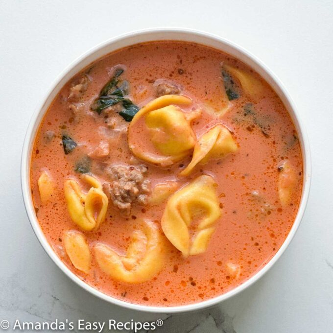 Bowl full of creamy sausage tortellini soup.