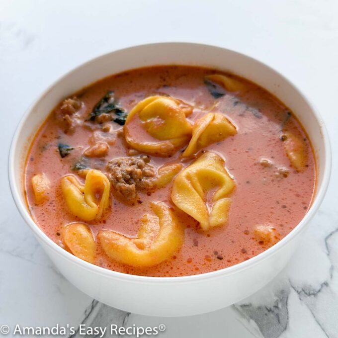 Bowl full of sausage tortellini soup.