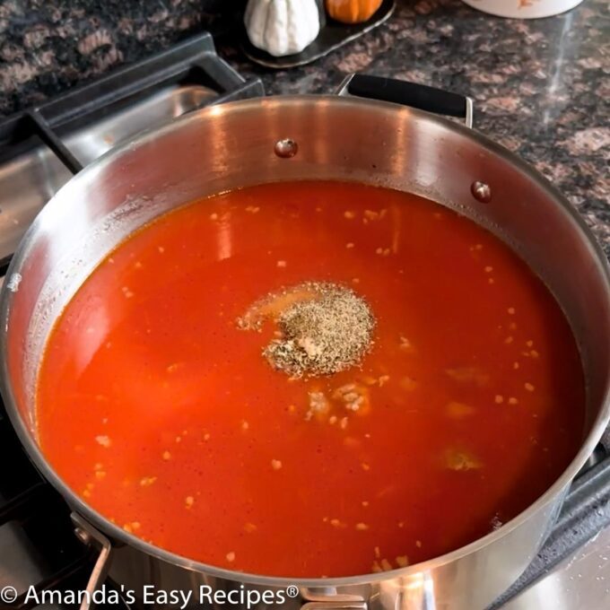 Adding seasonings to the pot.