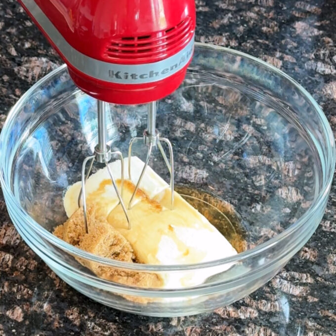 Mixing bowl with cream cheese, brown sugar, and vanilla.