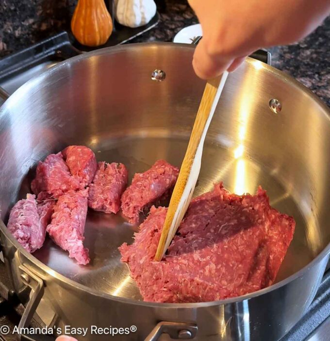Ground beef being cooked in a soup pot.