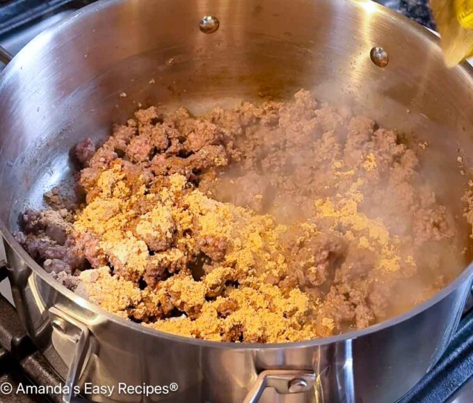 Taco seasoning being added to the beef.