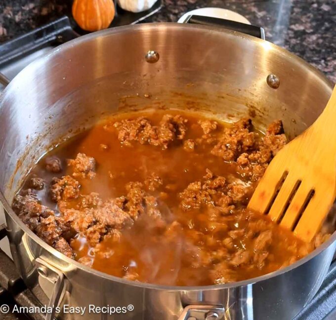 Beef broth being added to the pot.
